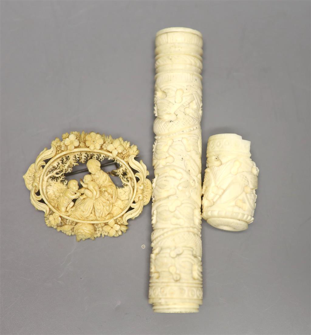 A 19th century carved ivory needlecase, length 15cm, and a brooch